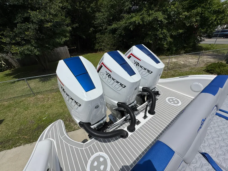 Slide: The Image of 2026 Fountain 39 DX boat with triple racing outboard engines, docked outdoors. - 41