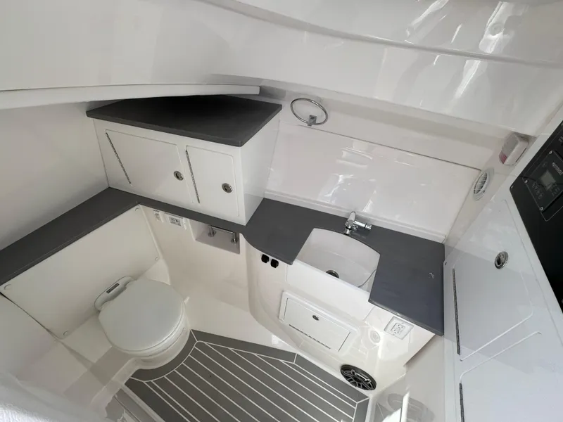 Slide: The Image of 2026 Fountain 39 DX boat interior with modern bathroom, featuring sink, toilet, and storage cabinets. - 43