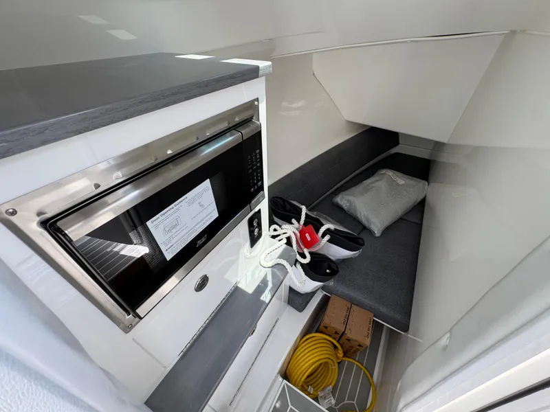 Slide: The Image of Interior cabin of 2026 Fountain 39 DX boat with microwave and storage space. - 46