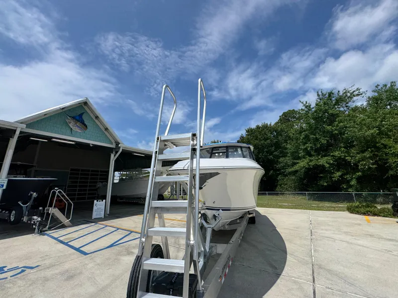Slide: The Image of 2026 Fountain 39 DX boat on trailer under clear sky at marina. - 6