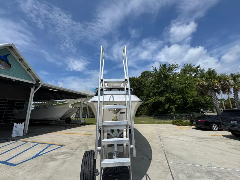 Slide: The Image of Staircase leading to a 2026 Fountain 39 DX boat under a clear blue sky. - 7