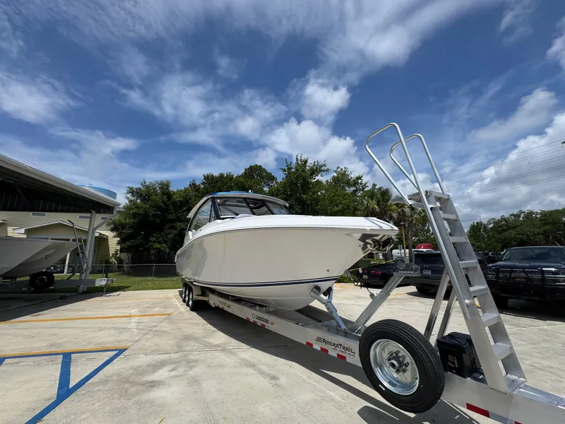 Slide: The Image of 2026 Fountain 39 DX boat on trailer under a partly cloudy sky. - 8