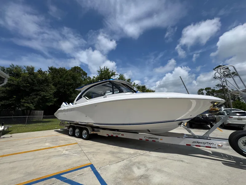 Slide: The Image of 2026 Fountain 39 DX boat on trailer under blue sky. - 9