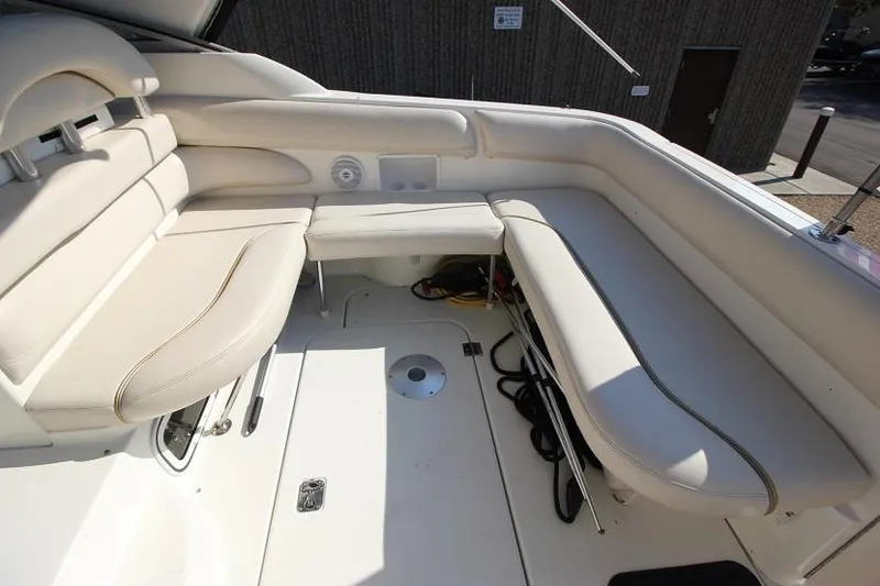 Slide: The Image of 2005 Larson Cabrio 310 boat interior with white cushioned seating. - 4