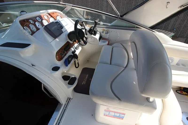 Slide: The Image of 2005 Larson Cabrio 310 boat cockpit with steering wheel and control panel. - 6
