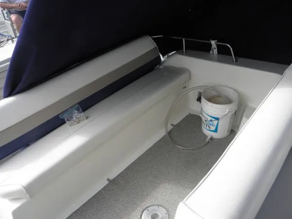 Slide: The Image of 1999 Rinker 280 Fiesta Vee boat interior with seating and a bucket. - 11