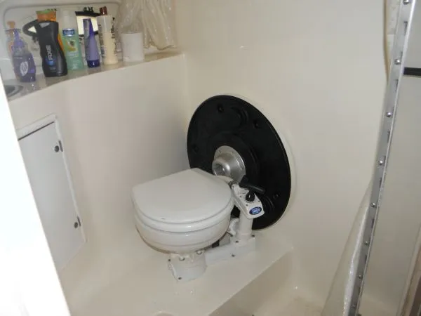 Slide: The Image of 1999 Rinker 280 Fiesta Vee boat bathroom with toilet and toiletries. - 9