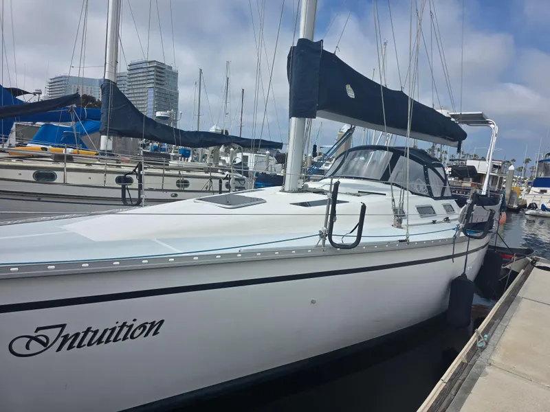 The Image of 1989 Hunter Legend 37 sailboat named "Intuition" docked at a marina. - 0
