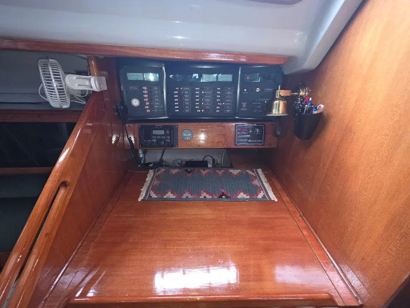 Slide: The Image of 1989 Hunter Legend 37 yacht interior with navigation equipment and wooden finish. - 11