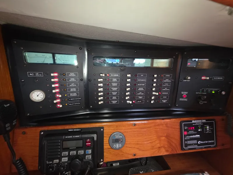 Slide: The Image of Control panel of a 1989 Hunter Legend 37 sailboat, featuring various switches and gauges. - 12