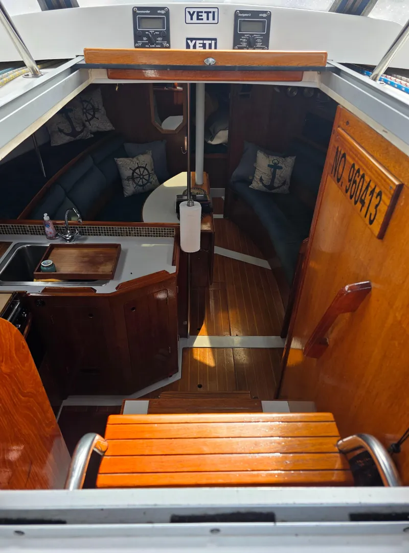 Slide: The Image of Interior view of 1989 Hunter Legend 37 sailboat with wooden finishes and nautical decor. - 14