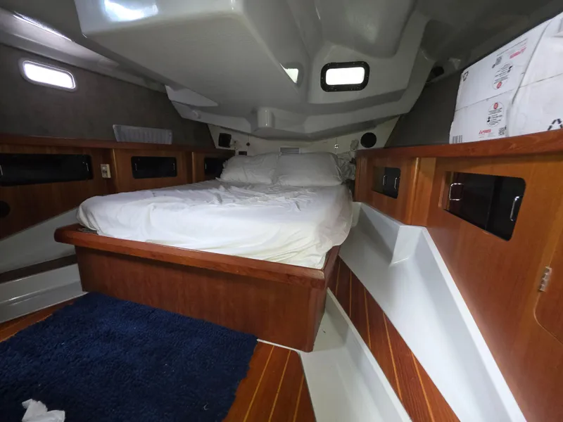 Slide: The Image of Interior cabin of 1989 Hunter Legend 37 sailboat with bed and wooden accents. - 16