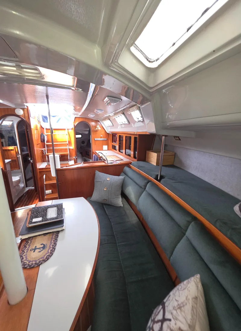 Slide: The Image of Interior of 1989 Hunter Legend 37 sailboat with cozy seating and wooden accents. - 17