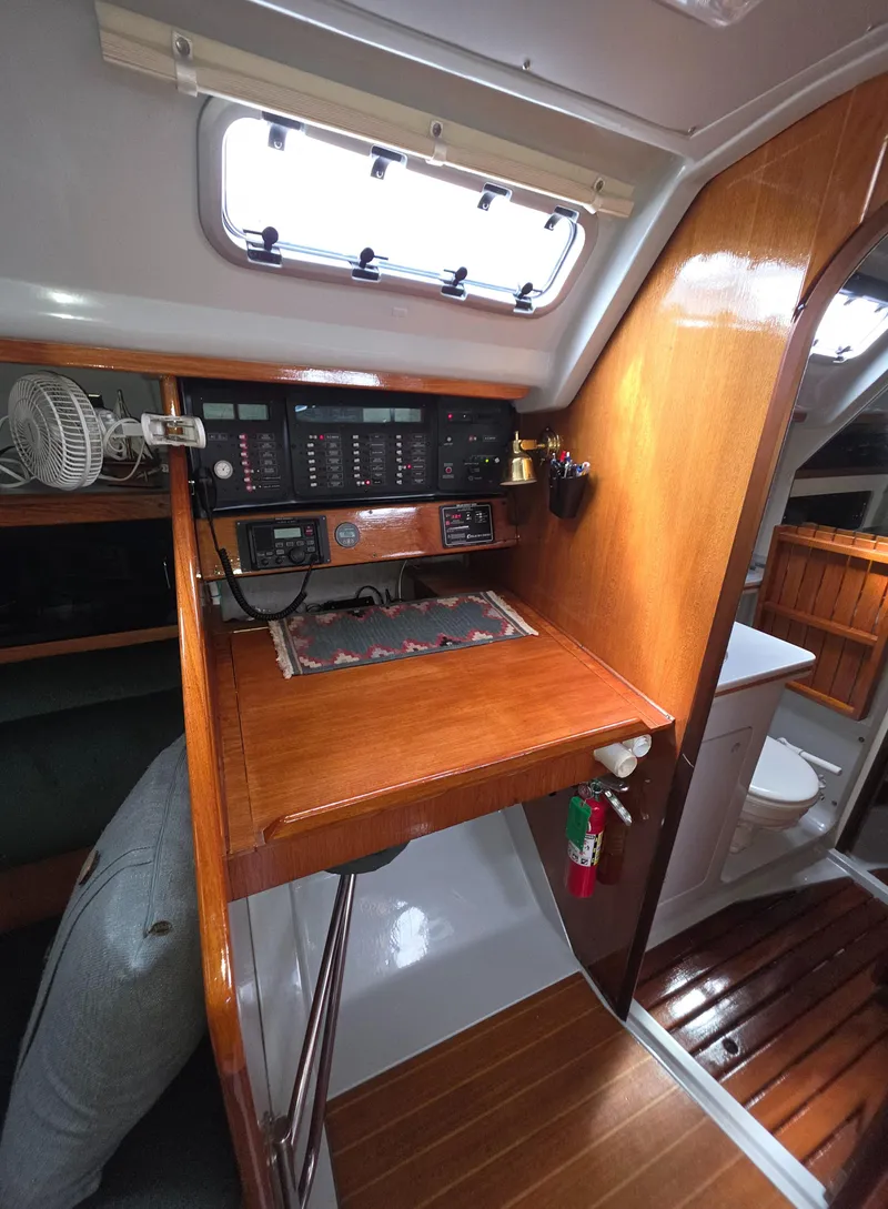 Slide: The Image of 1989 Hunter Legend 37 yacht interior with navigation station and wooden cabinetry. - 22