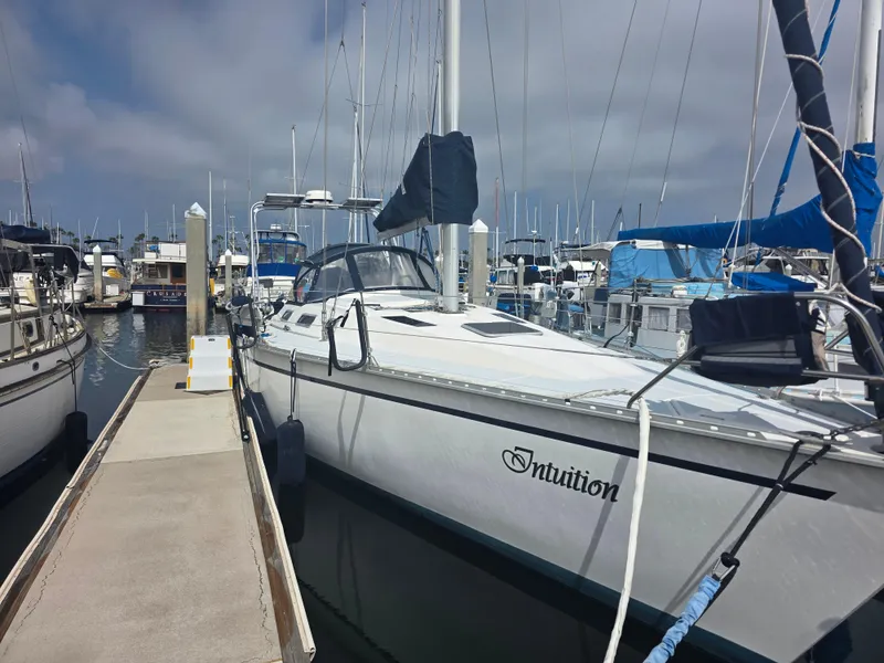 Slide: The Image of 1989 Hunter Legend 37 sailboat named "Intuition" docked at a marina. - 3