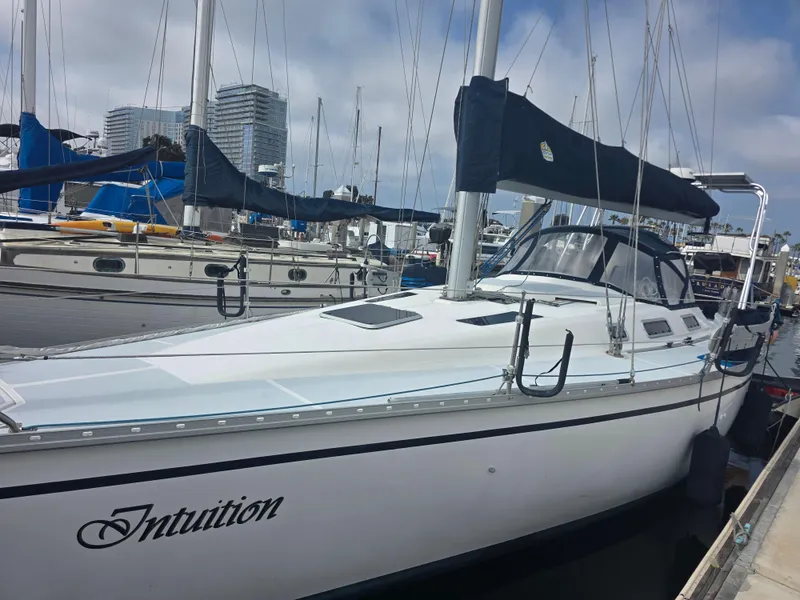Slide: The Image of 1989 Hunter Legend 37 sailboat docked at marina, named "Intuition." - 4
