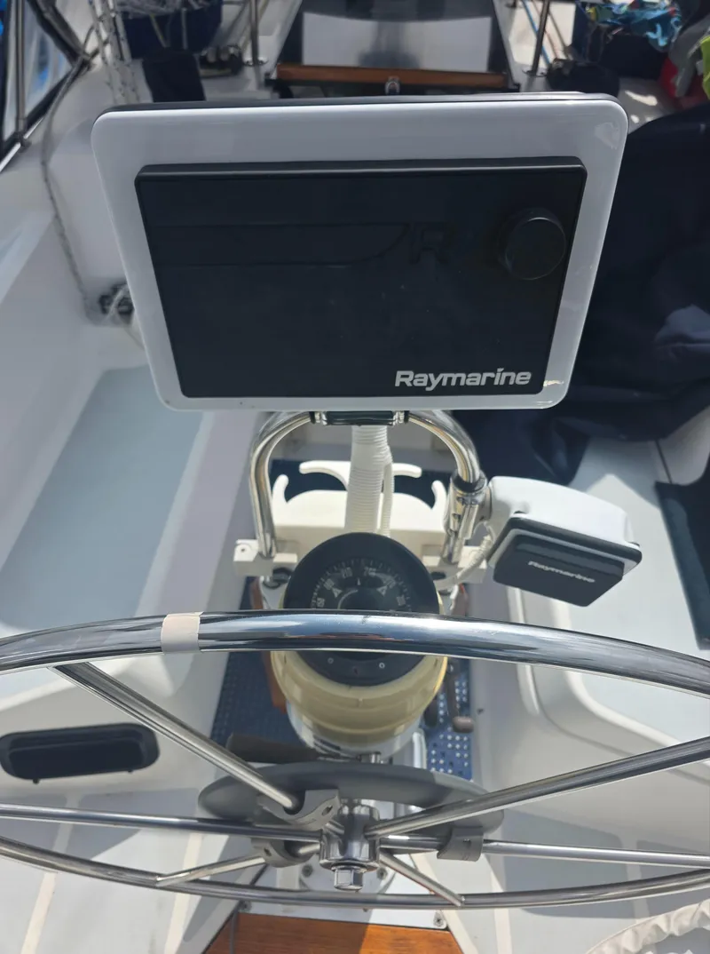 Slide: The Image of Steering wheel and Raymarine navigation system on 1989 Hunter Legend 37 sailboat. - 7