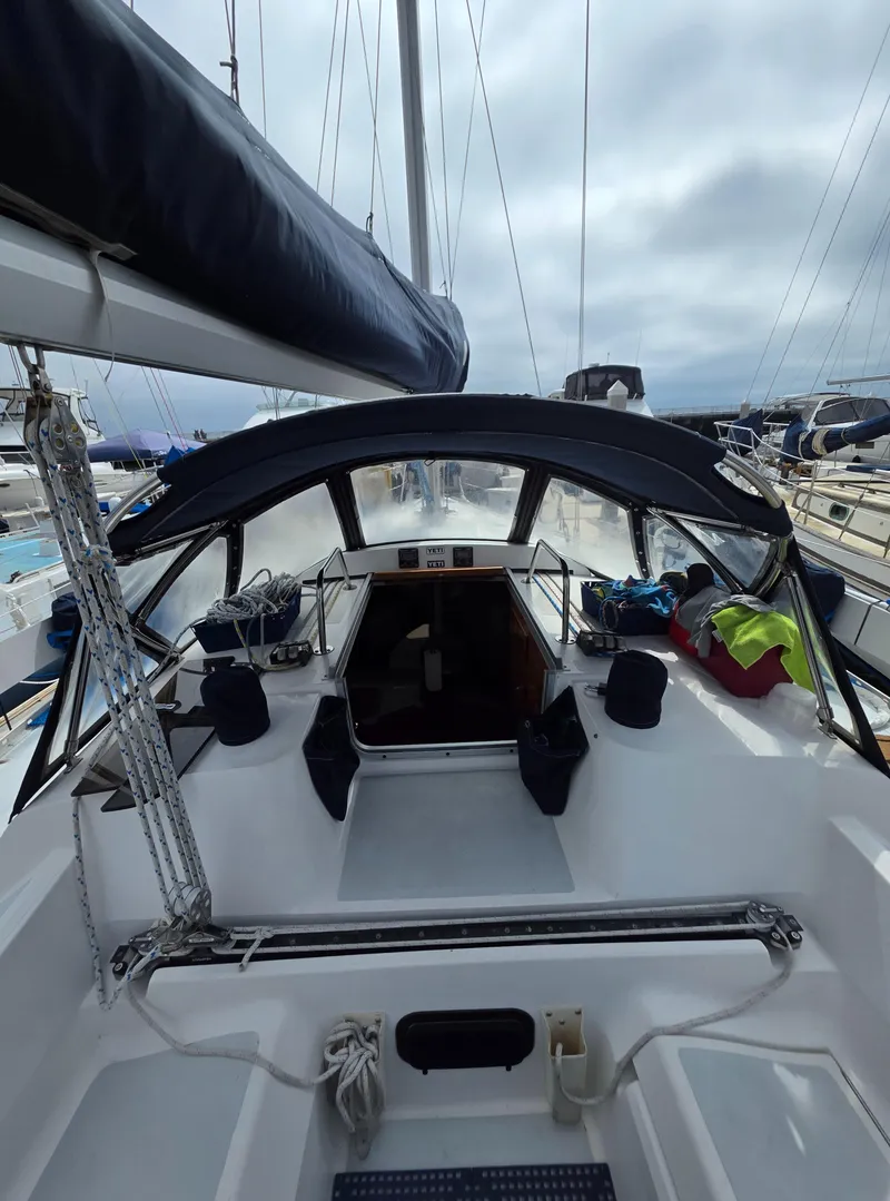 Slide: The Image of 1989 Hunter Legend 37 sailboat cockpit with canopy, docked in a marina. - 8