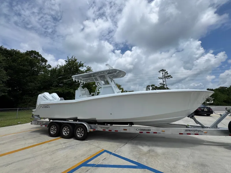 Slide: The Image of 2026 Invincible 33 Open Fisherman boat on trailer under cloudy sky. - 10