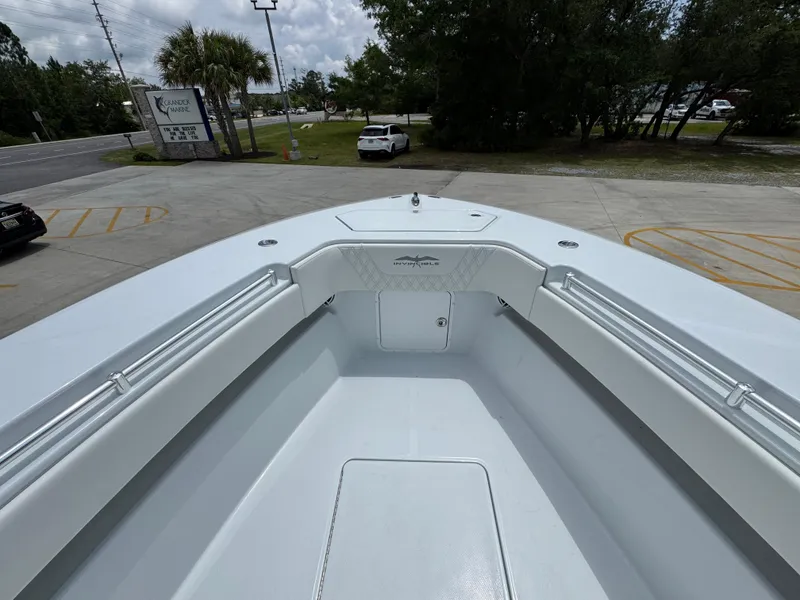 Slide: The Image of 2026 Invincible 33 Open Fisherman boat, spacious deck view, parked outdoors. - 21