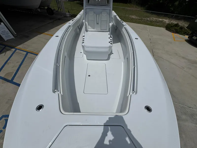 Slide: The Image of 2026 Invincible 33 Open Fisherman boat, spacious deck view, sleek design, outdoor setting. - 23