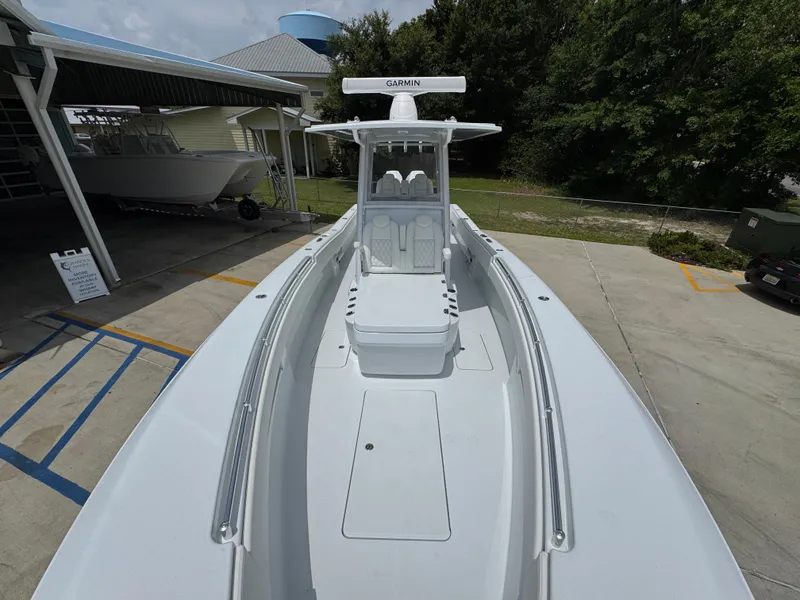 Slide: The Image of 2026 Invincible 33 Open Fisherman boat, sleek design, docked outdoors. - 24