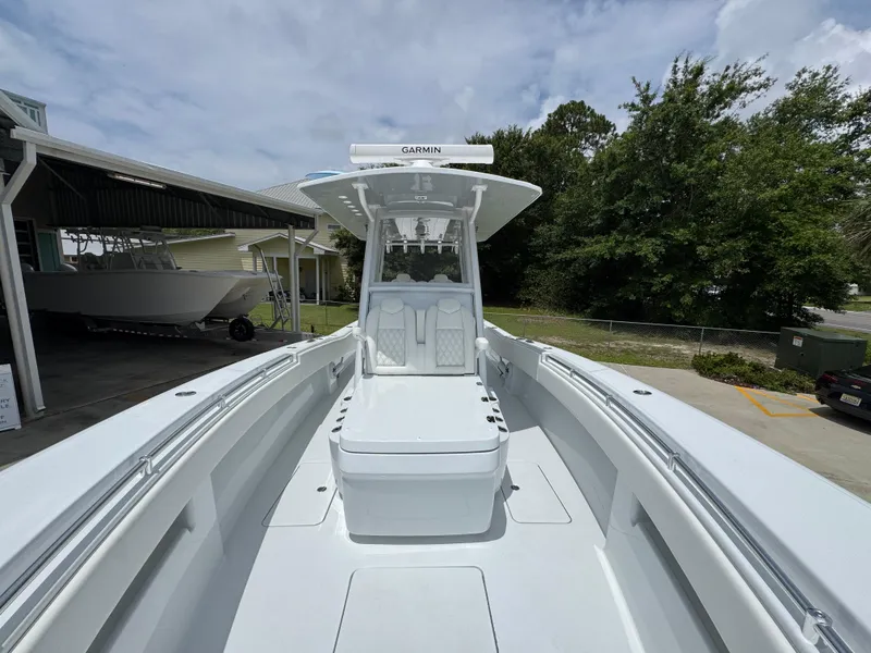 Slide: The Image of 2026 Invincible 33 Open Fisherman boat with sleek design, docked outdoors. - 25