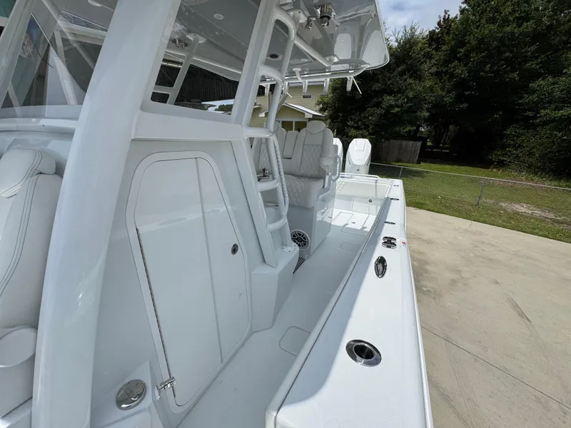 Slide: The Image of 2026 Invincible 33 Open Fisherman boat, sleek white design, spacious deck, modern features. - 27