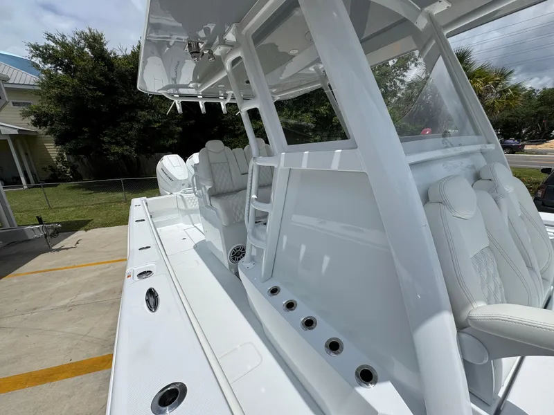 Slide: The Image of 2026 Invincible 33 Open Fisherman boat, sleek white design, spacious deck, modern features. - 28