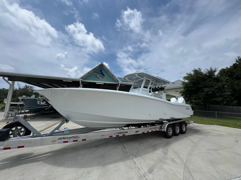 Slide: The Image of 2026 Invincible 33 Open Fisherman boat on a trailer under a cloudy sky. - 3