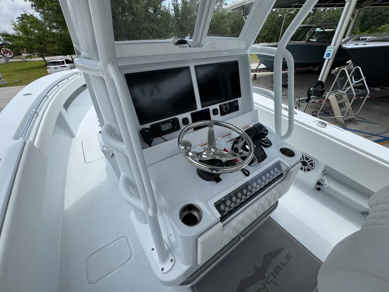 Slide: The Image of 2026 Invincible 33 Open Fisherman boat console with dual screens and steering wheel. - 34