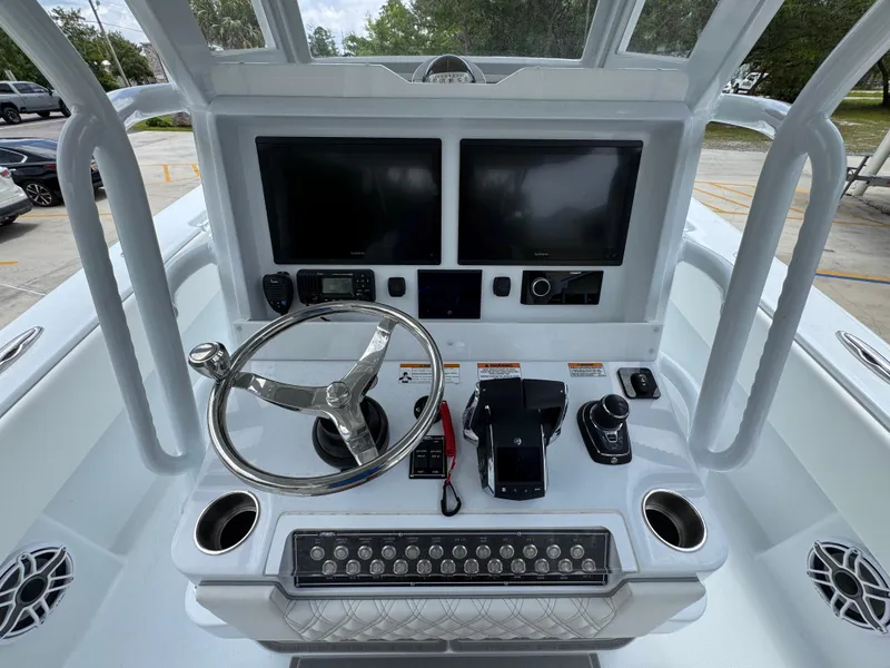 Slide: The Image of 2026 Invincible 33 Open Fisherman boat console with dual screens and steering wheel. - 35