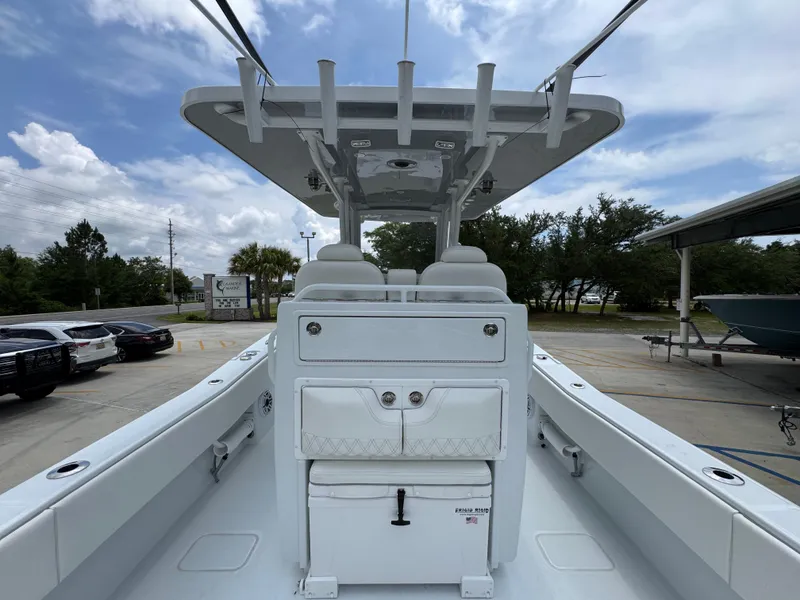 Slide: The Image of 2026 Invincible 33 Open Fisherman boat, spacious deck, modern design, parked outdoors. - 38