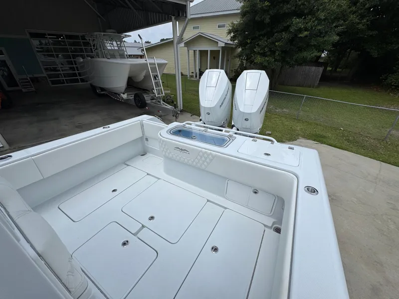 Slide: The Image of 2026 Invincible 33 Open Fisherman boat with dual engines, docked outdoors. - 39