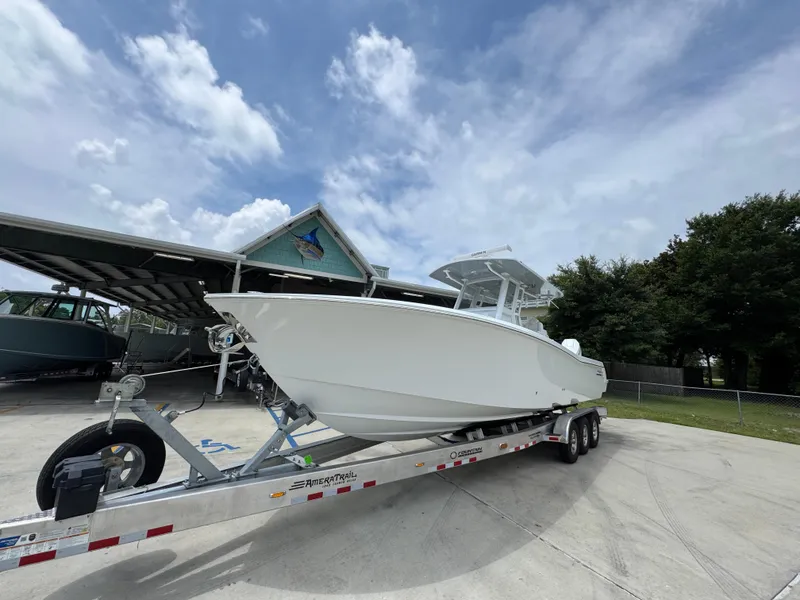 Slide: The Image of 2026 Invincible 33 Open Fisherman boat on trailer under cloudy sky. - 4