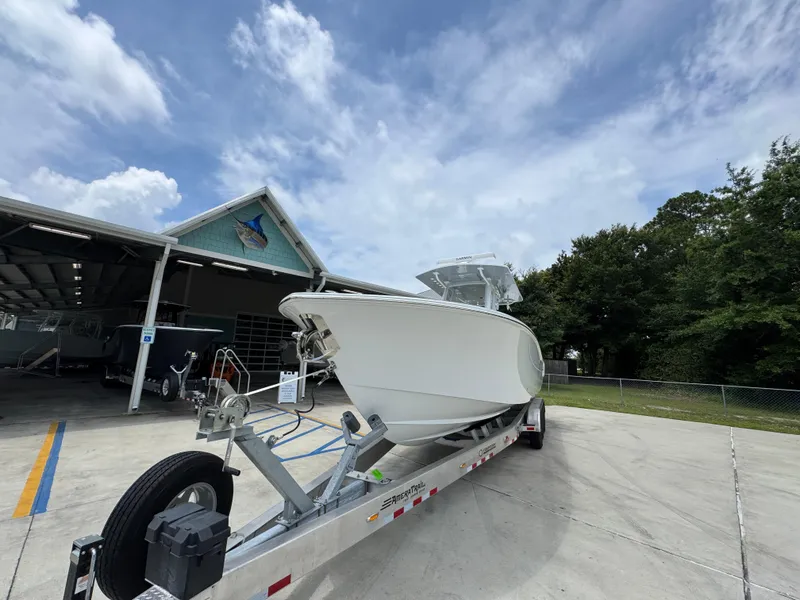 Slide: The Image of 2026 Invincible 33 Open Fisherman boat on trailer, parked outside a storage facility. - 5