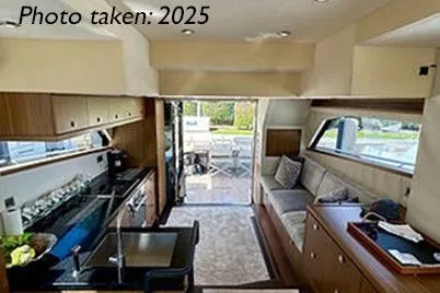 Slide: The Image of Interior of 2015 Mazarin 72 Sport Fly yacht, featuring modern kitchen and seating area. - 47