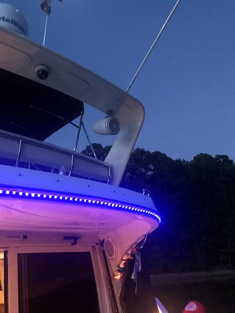 Slide: The Image of 2004 Carver 360 Sport Sedan with blue LED lights at dusk. - 15