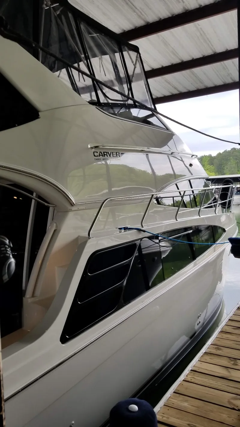 Slide: The Image of 2004 Carver 360 Sport Sedan docked under a covered marina. - 21