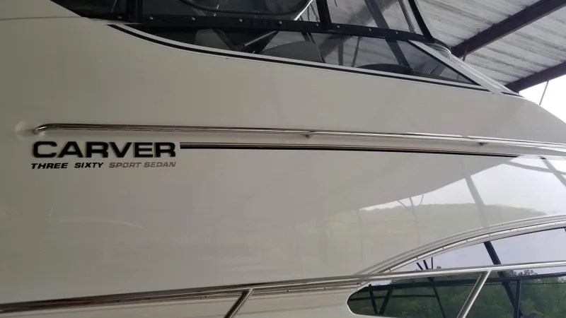 Slide: The Image of 2004 Carver 360 Sport Sedan boat side view with logo under a canopy. - 22