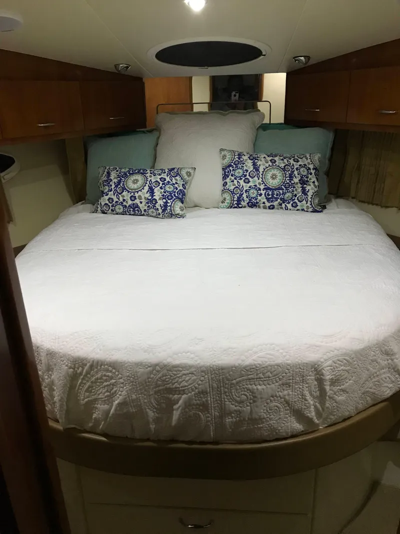 Slide: The Image of Luxurious bedroom interior of 2004 Carver 360 Sport Sedan with elegant bedding and wood cabinetry. - 30