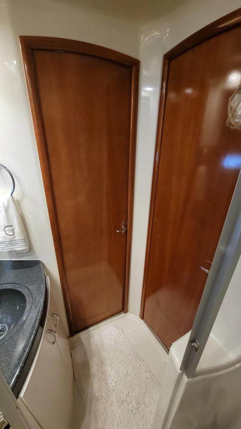 Slide: The Image of 2004 Carver 360 Sport Sedan interior with wooden doors and compact bathroom design. - 35