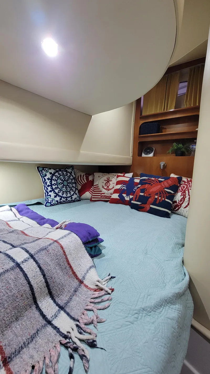 Slide: The Image of Cozy cabin interior of a 2004 Carver 360 Sport Sedan with decorative pillows and blankets. - 37