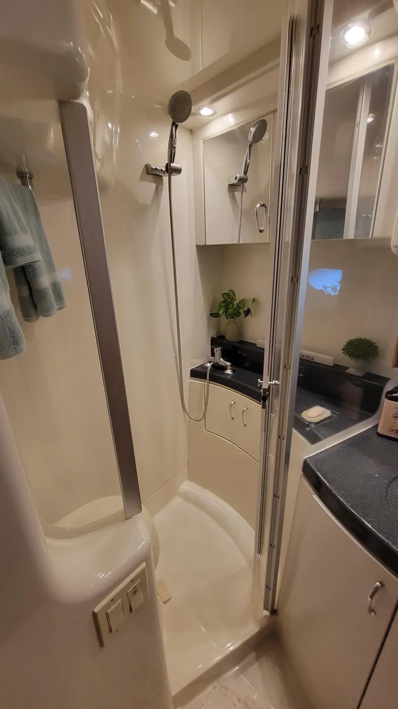 Slide: The Image of 2004 Carver 360 Sport Sedan bathroom with shower, modern fixtures, and sleek cabinetry. - 39