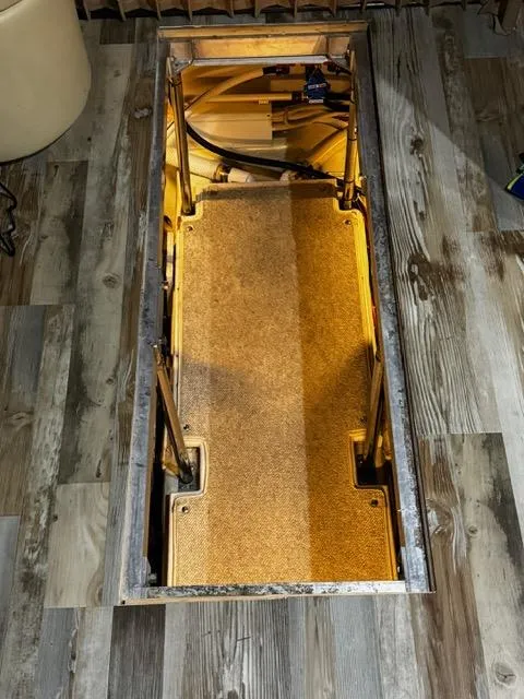 Slide: The Image of 2004 Carver 360 Sport Sedan interior compartment with wooden flooring and storage space. - 41