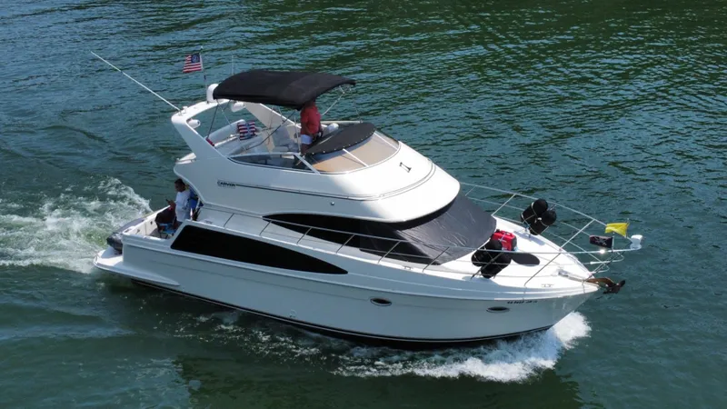 Slide: The Image of 2004 Carver 360 Sport Sedan cruising on water, featuring sleek design and spacious deck. - 5