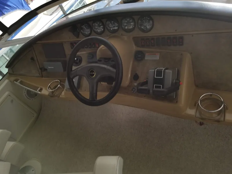 Slide: The Image of 2004 Carver 360 Sport Sedan dashboard with steering wheel and control panel. - 9