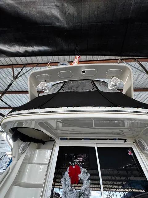Slide: The Image of 2004 Carver 360 Sport Sedan yacht under a covered dock, rear view. - 12