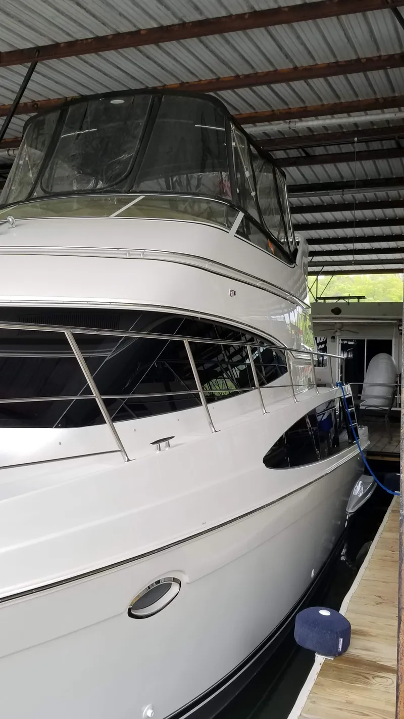 Slide: The Image of 2004 Carver 360 Sport Sedan yacht docked in covered marina. - 19