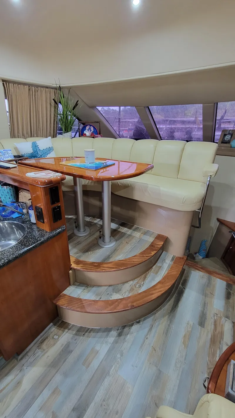 Slide: The Image of Interior of 2004 Carver 360 Sport Sedan with seating and dining area. - 23